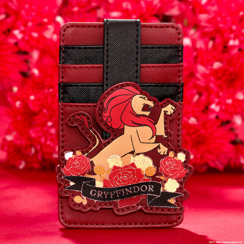 Maroon and black card holder, featuring an appliqué of the Gryffindor lion front and center surrounded by white and red flowers, sitting against a red background in front of a real bouquet of red flowers 